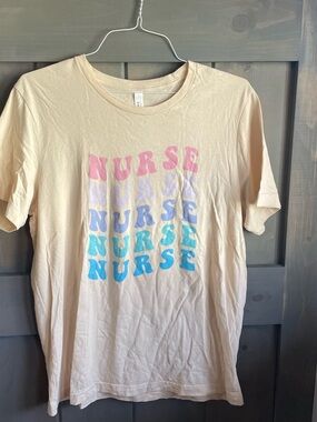 Cream Cotton Graphic Tee with Pink Print. Nurse tee for work